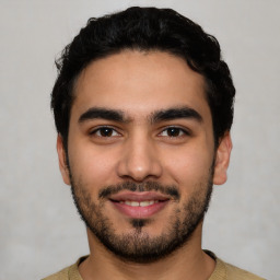 Joyful latino young-adult male with short  black hair and brown eyes