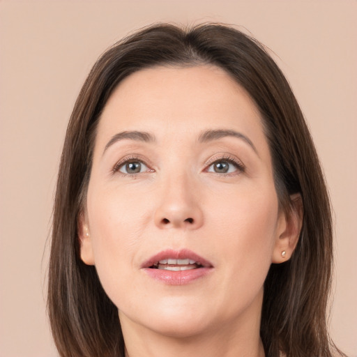 Joyful white adult female with long  brown hair and brown eyes