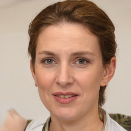 Joyful white adult female with medium  brown hair and grey eyes