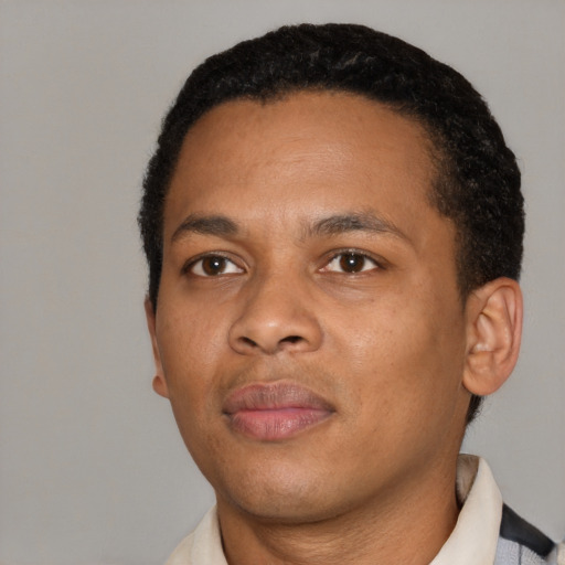 Joyful black young-adult male with short  black hair and brown eyes