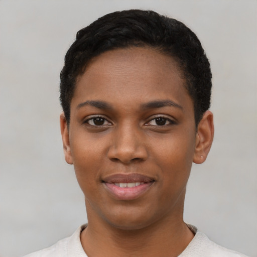 Joyful black young-adult female with short  black hair and brown eyes
