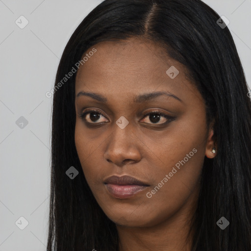 Joyful black young-adult female with long  black hair and brown eyes