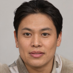 Joyful asian young-adult male with short  brown hair and brown eyes