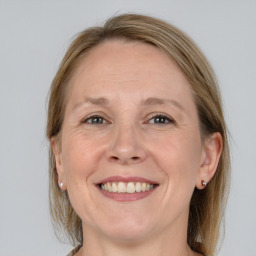 Joyful white adult female with medium  brown hair and grey eyes