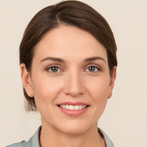 Joyful white young-adult female with short  brown hair and grey eyes