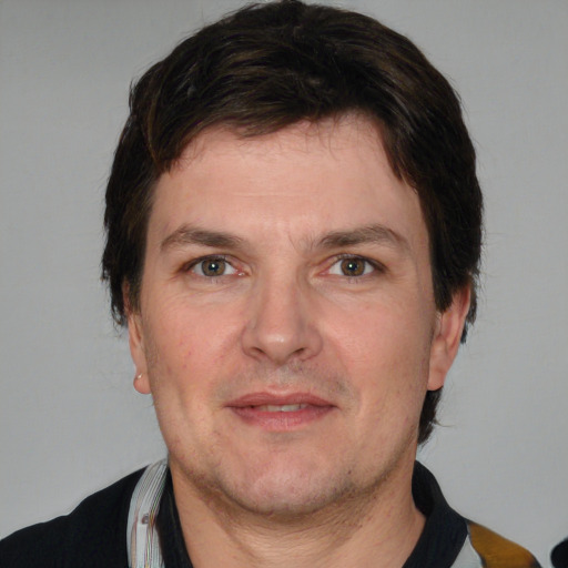 Joyful white adult male with short  brown hair and grey eyes