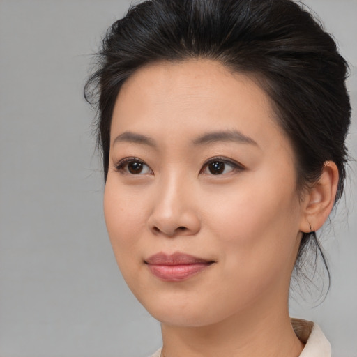 Joyful asian young-adult female with medium  brown hair and brown eyes