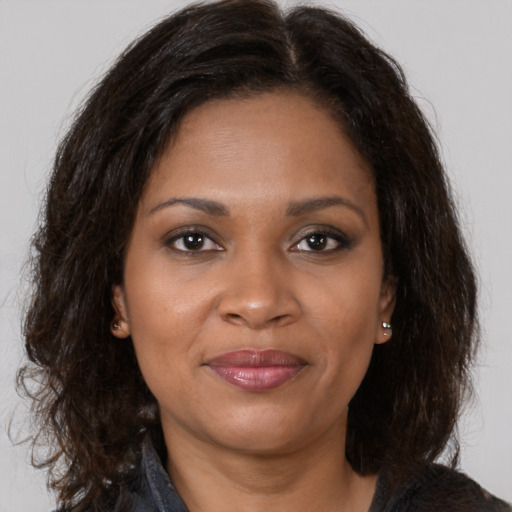 Joyful black young-adult female with medium  brown hair and brown eyes