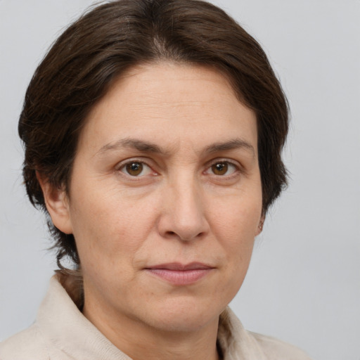 Joyful white adult female with medium  brown hair and brown eyes