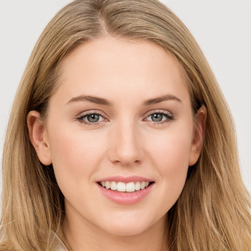 Joyful white young-adult female with long  brown hair and blue eyes