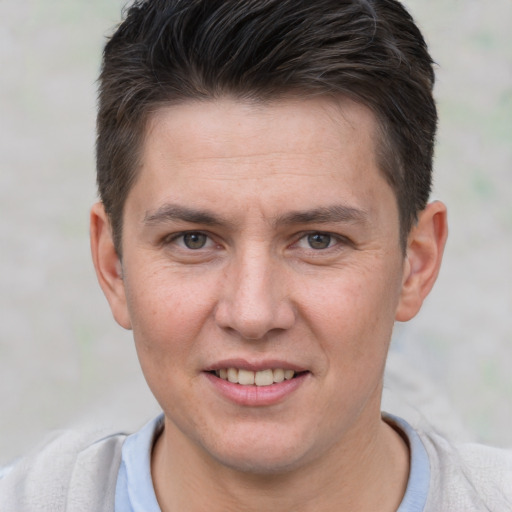 Joyful white young-adult male with short  brown hair and brown eyes