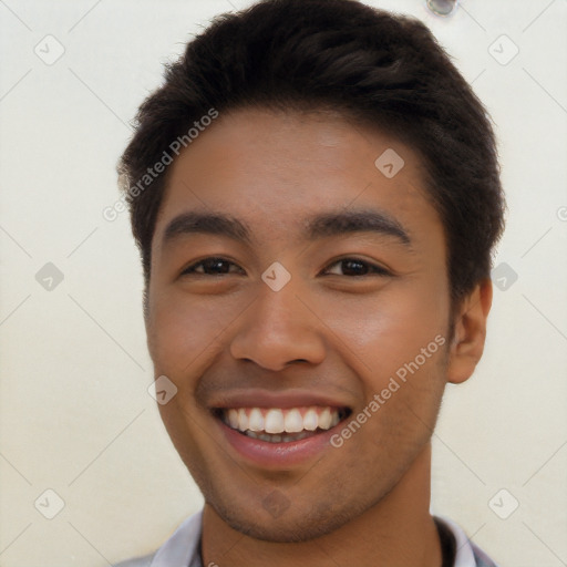 Joyful latino young-adult male with short  brown hair and brown eyes