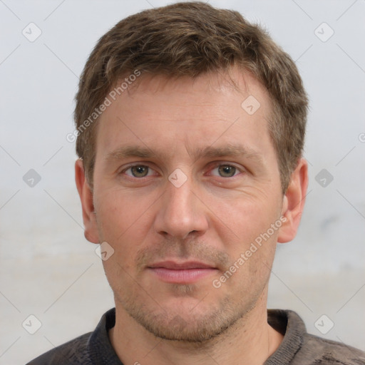 Joyful white adult male with short  brown hair and grey eyes