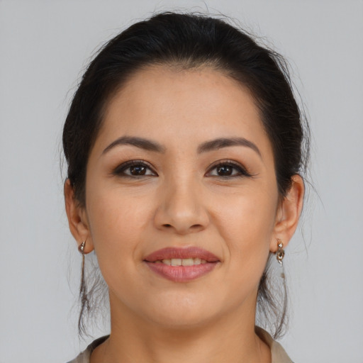 Joyful latino young-adult female with long  brown hair and brown eyes