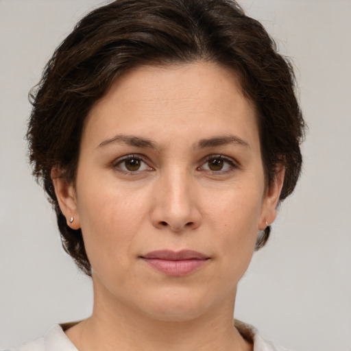 Joyful white adult female with short  brown hair and brown eyes