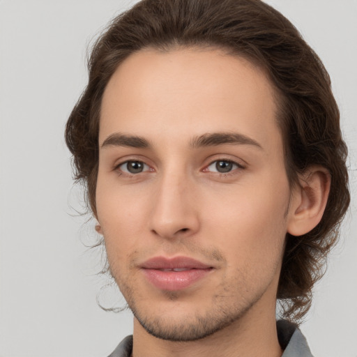 Joyful white young-adult male with medium  brown hair and brown eyes