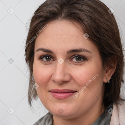 Joyful white adult female with medium  brown hair and grey eyes