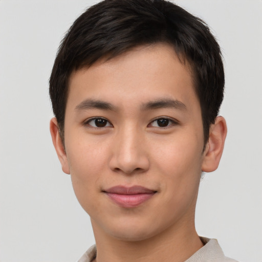 Joyful asian young-adult male with short  brown hair and brown eyes