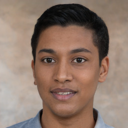 Joyful latino young-adult male with short  black hair and brown eyes