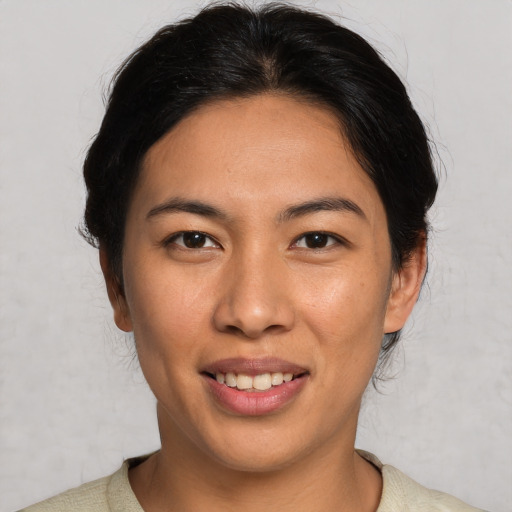Joyful asian young-adult female with short  brown hair and brown eyes
