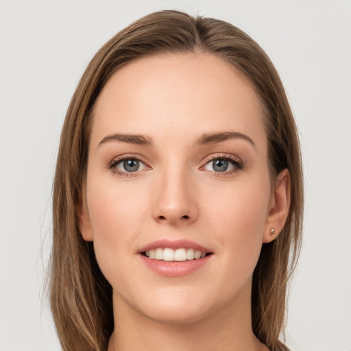 Joyful white young-adult female with long  brown hair and grey eyes