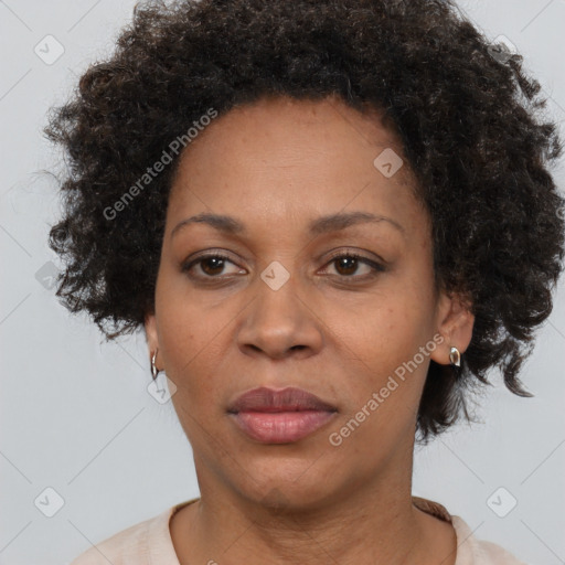 Joyful black adult female with short  brown hair and brown eyes