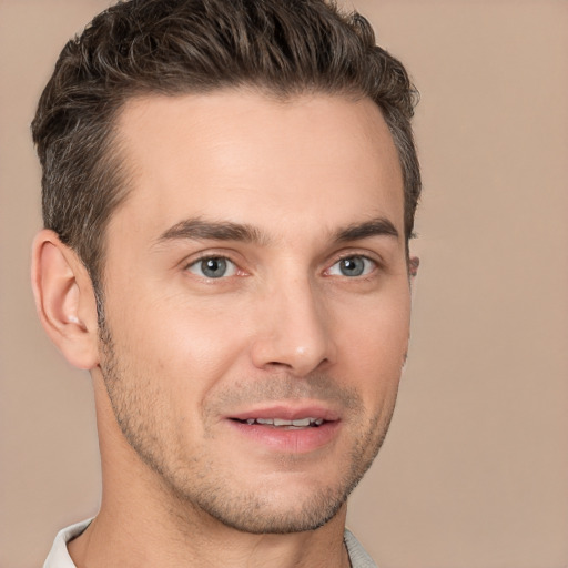 Joyful white young-adult male with short  brown hair and brown eyes