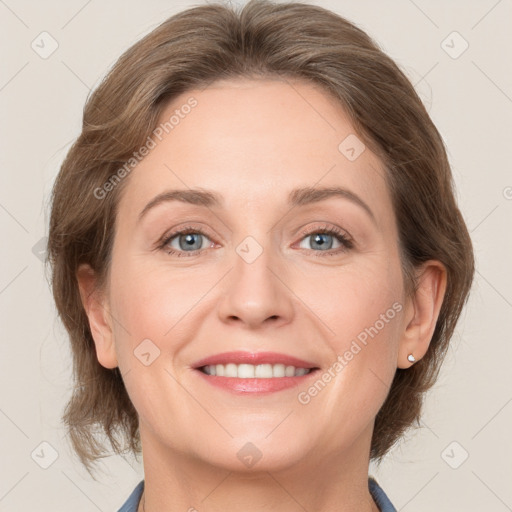 Joyful white adult female with medium  brown hair and grey eyes