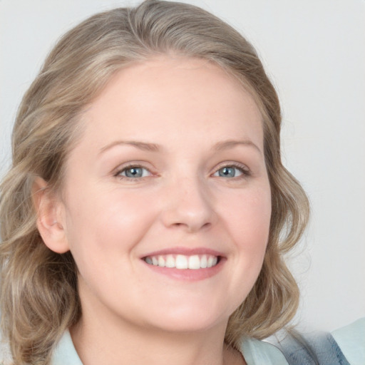 Joyful white young-adult female with medium  brown hair and blue eyes