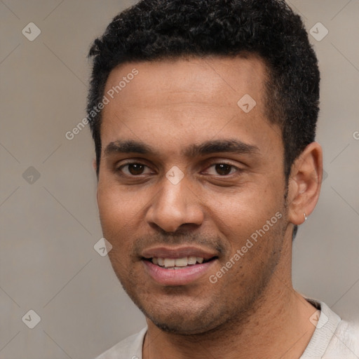 Joyful black young-adult male with short  black hair and brown eyes