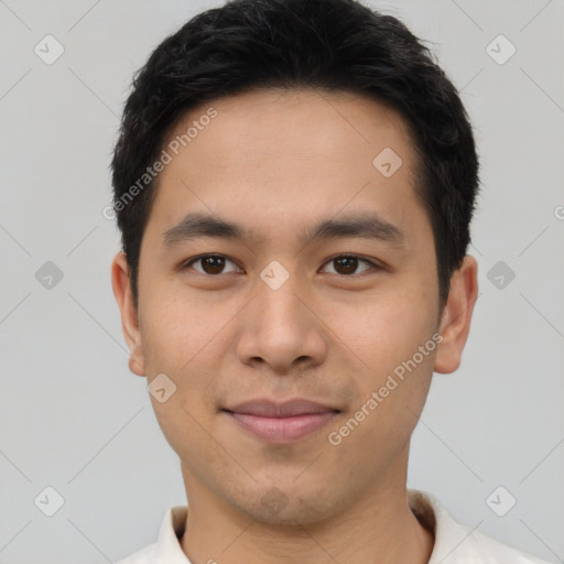 Joyful asian young-adult male with short  brown hair and brown eyes