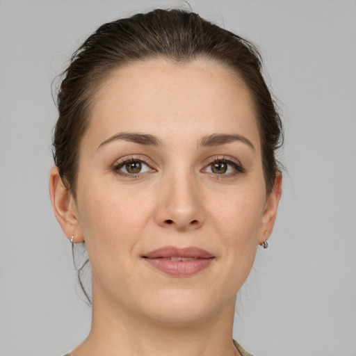 Joyful white young-adult female with short  brown hair and grey eyes