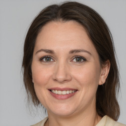 Joyful white adult female with medium  brown hair and brown eyes