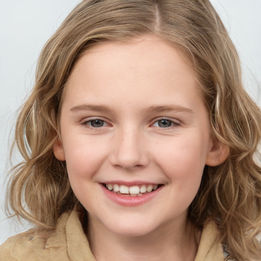 Joyful white child female with medium  brown hair and grey eyes