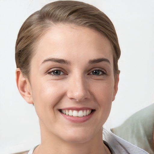 Joyful white young-adult female with short  brown hair and grey eyes