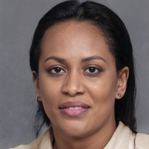 Joyful latino adult female with medium  black hair and brown eyes