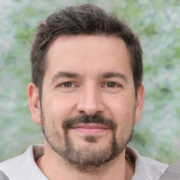 Joyful white adult male with short  brown hair and brown eyes