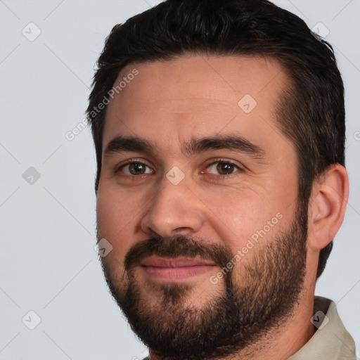 Joyful white young-adult male with short  black hair and brown eyes