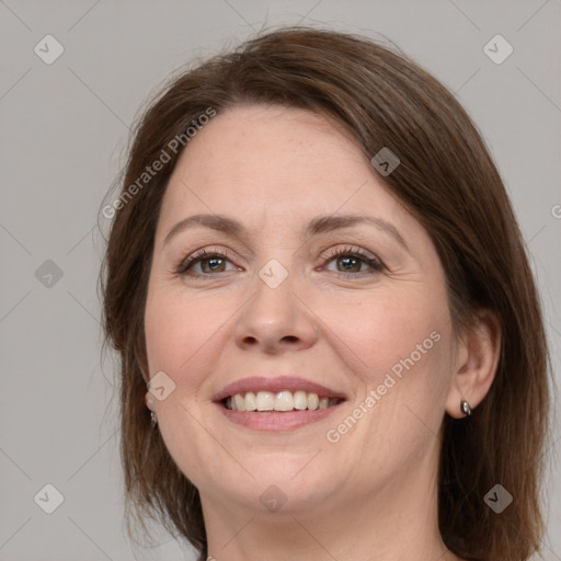 Joyful white adult female with medium  brown hair and grey eyes