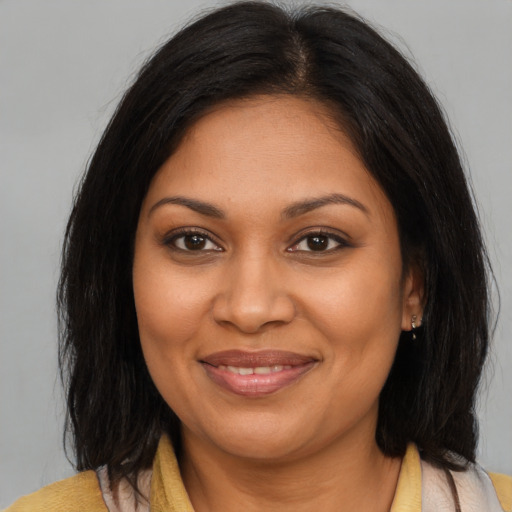 Joyful black young-adult female with medium  brown hair and brown eyes