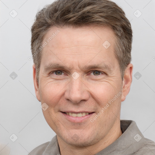 Joyful white adult male with short  brown hair and grey eyes