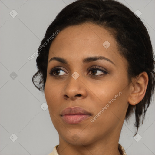 Joyful black young-adult female with medium  brown hair and brown eyes