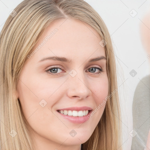 Joyful white young-adult female with long  brown hair and blue eyes