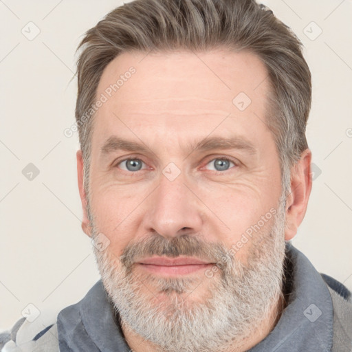 Joyful white adult male with short  brown hair and grey eyes