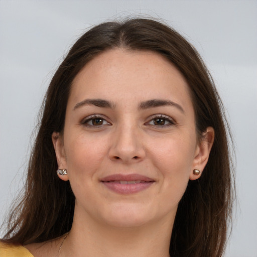 Joyful white young-adult female with long  brown hair and grey eyes