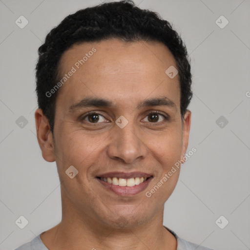 Joyful latino young-adult male with short  brown hair and brown eyes