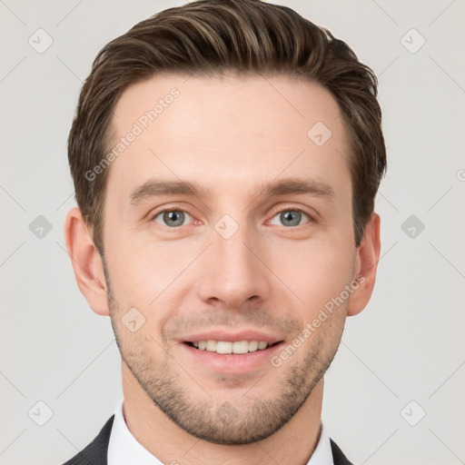 Joyful white young-adult male with short  brown hair and grey eyes