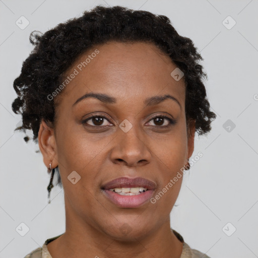 Joyful black adult female with short  brown hair and brown eyes