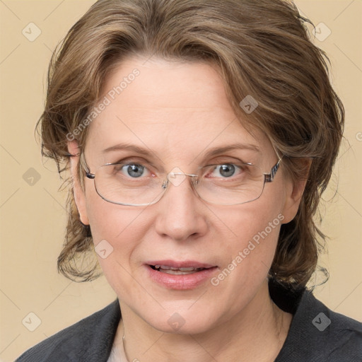 Joyful white adult female with medium  brown hair and blue eyes