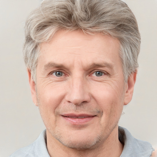 Joyful white middle-aged male with short  gray hair and grey eyes